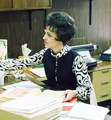 Mary Sheridan assists someone in the LBC office