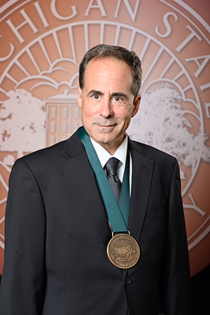 Dr. Mark Kay with the MSU Distinguished Alumni medal around his neck