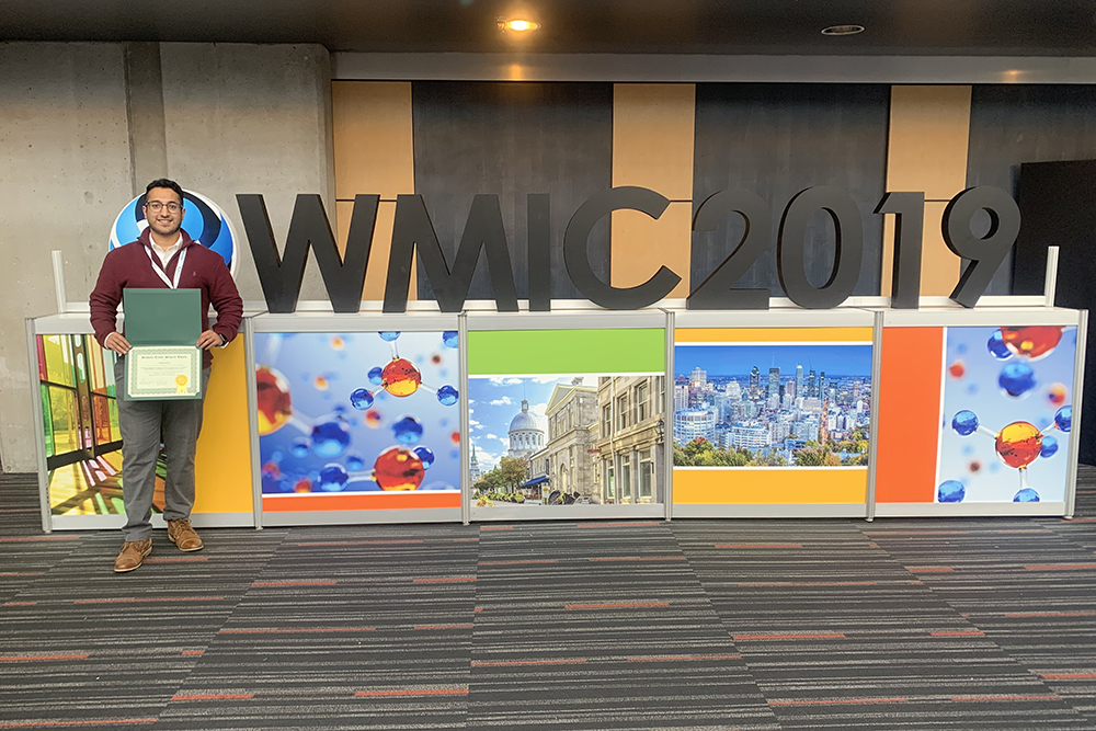 Hasaan Hayat with his award and the logo for the World Molecular Imaging Congress 2019