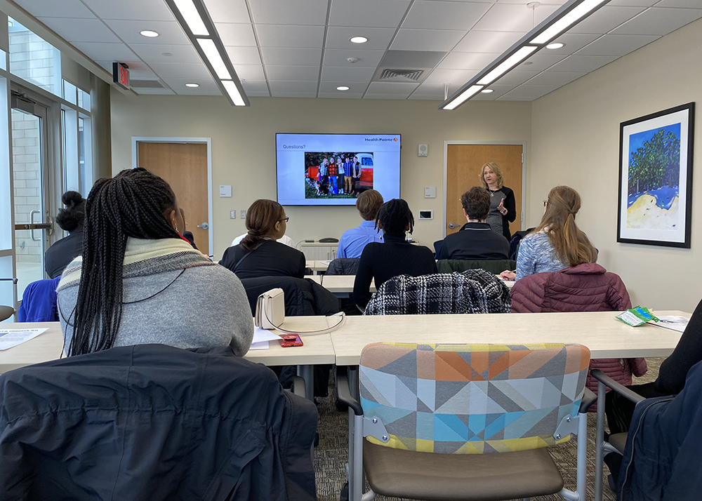 Molly Crissman presents about her career in a conference room