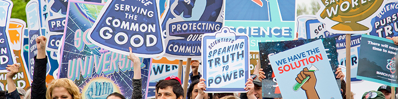 protest signs that promote science with sayings like "Science: Serving the Common Good." "Protecting our Communities" and "Scientists: Speaking Truth to Power"