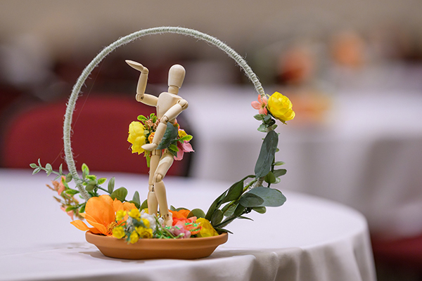 Centerpiece. Figurine surrounded by flowers, with flowers placed on their lower abdomen, signifying sexual health