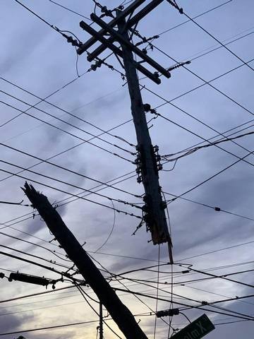 Power lines silhouetted against a blue sky