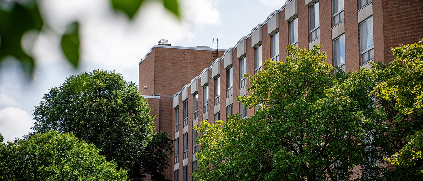 trees frame one of the wings of Holmes Hall, home to Lyman Briggs College