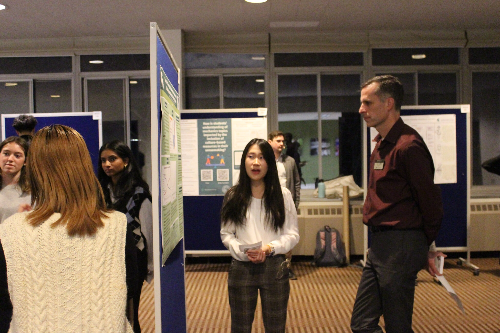 a student presents research to a faculty member at the 2024 Research Showcase