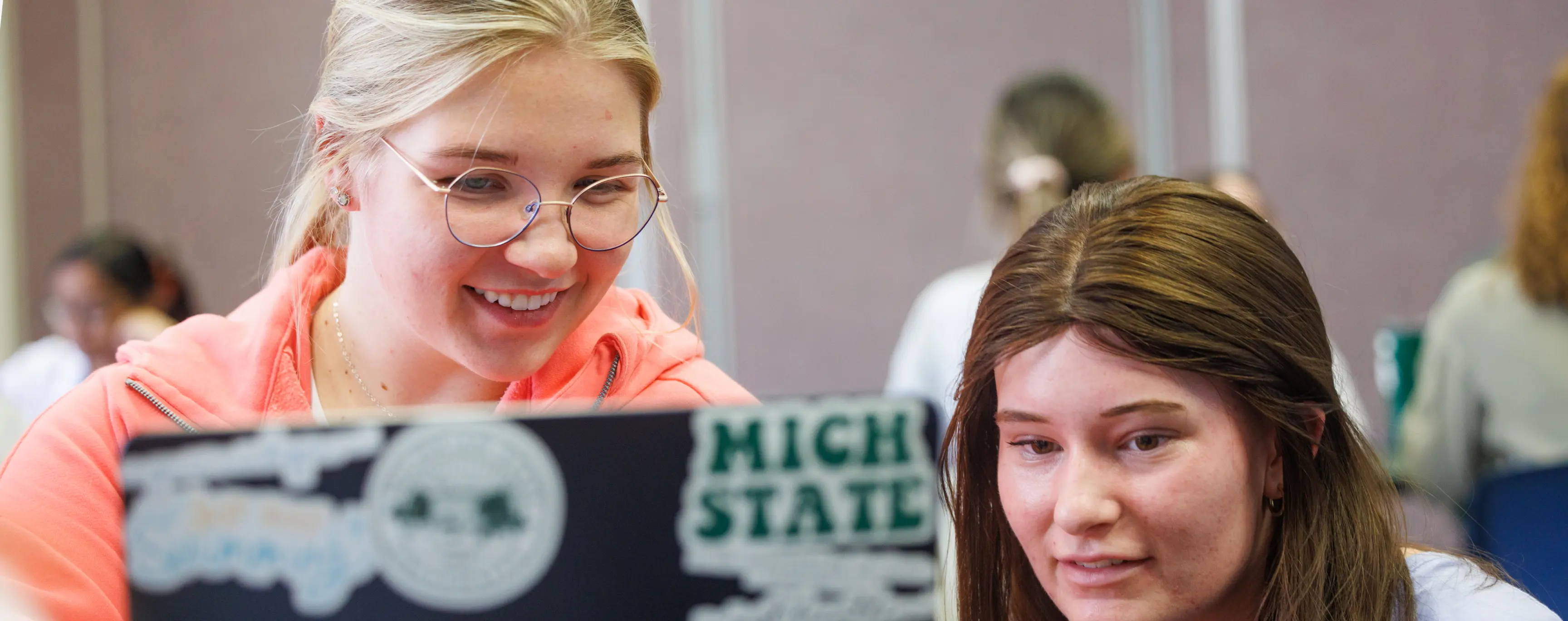 Students working together on a laptop