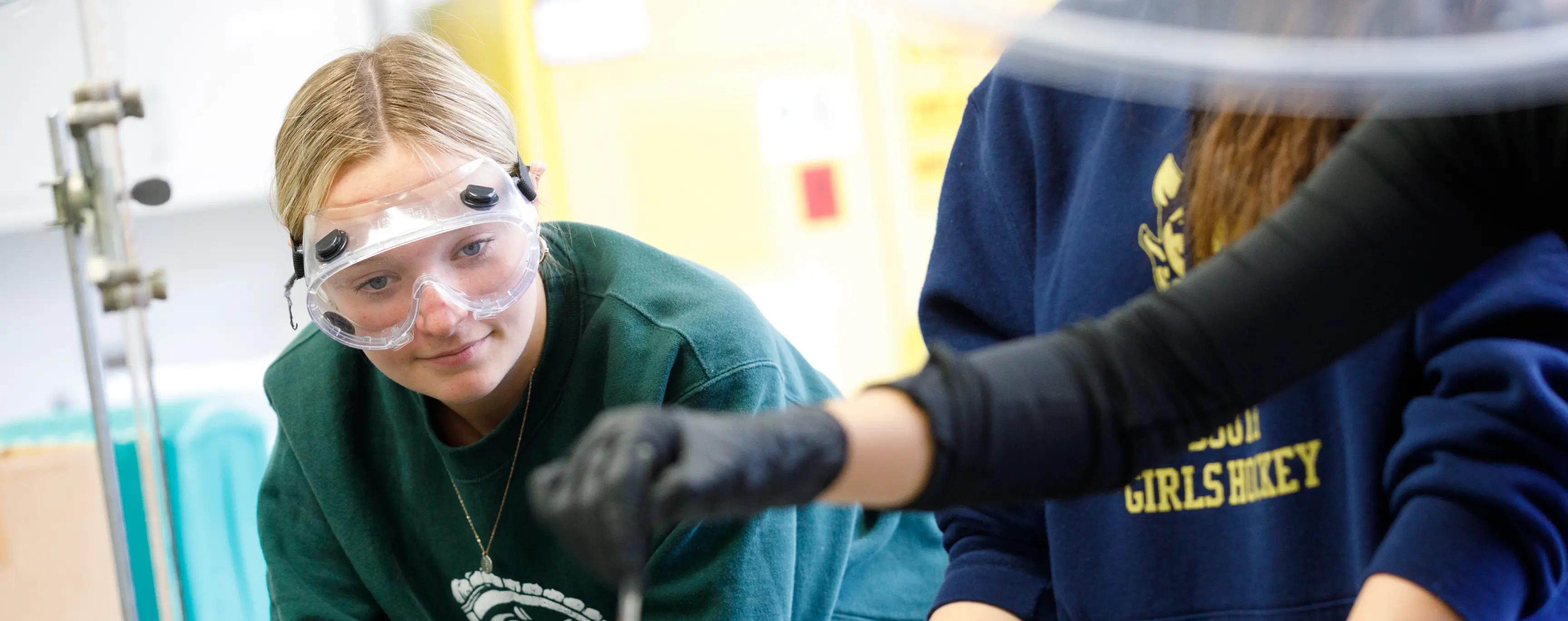Student wearing safey glasses working in a lab