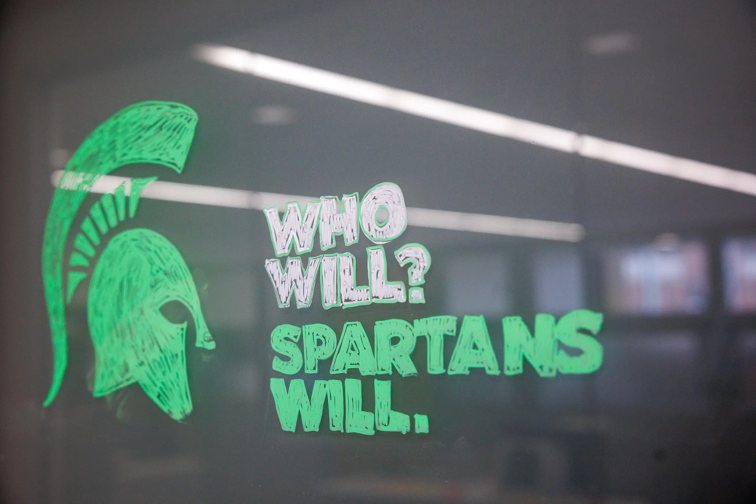 Handwritten Who Will? Spartans Will. next to a hand-drawn helmet