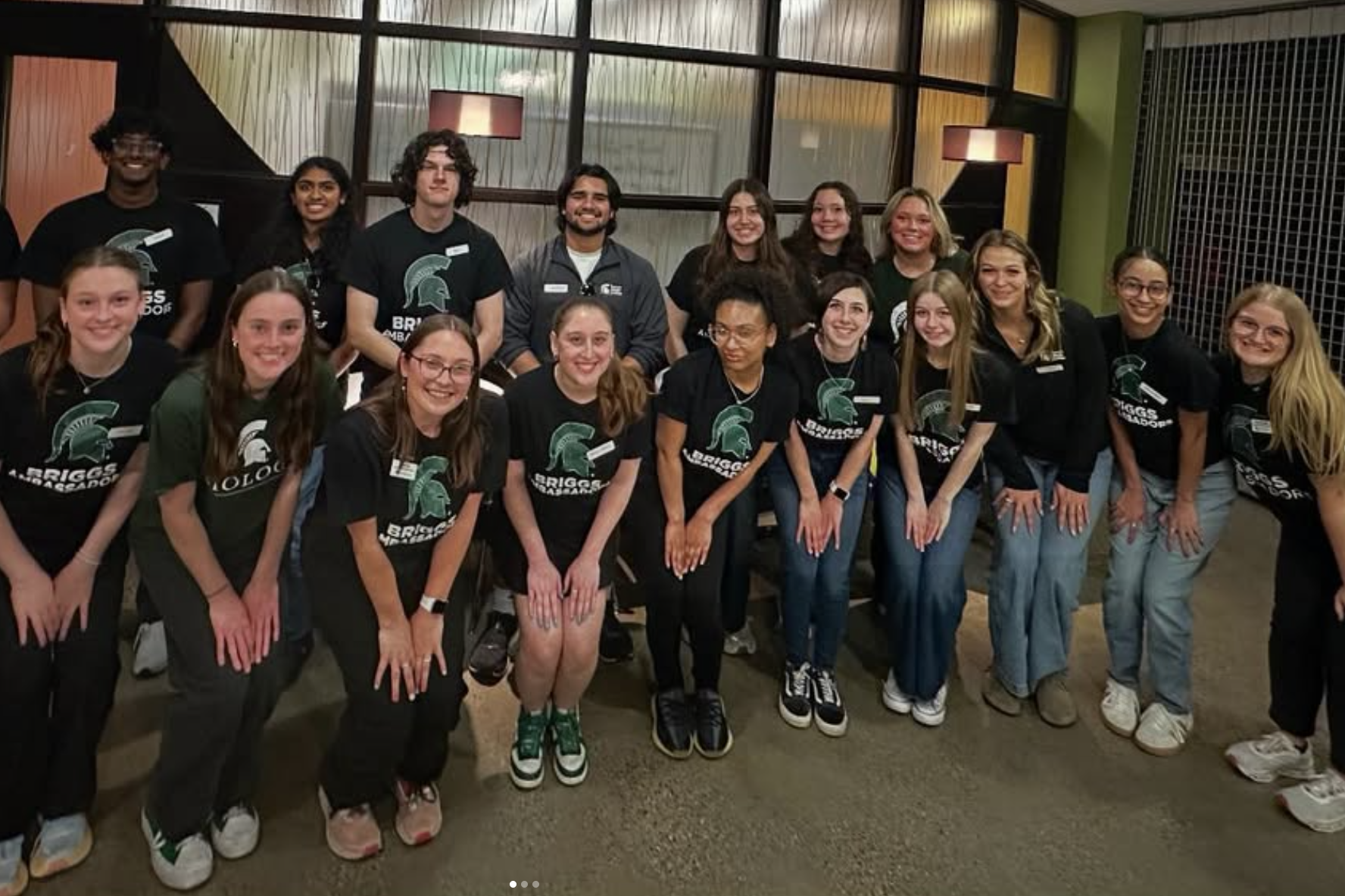 Students smile for a phonot. They're wearing Briggs Ambassador t-shirts