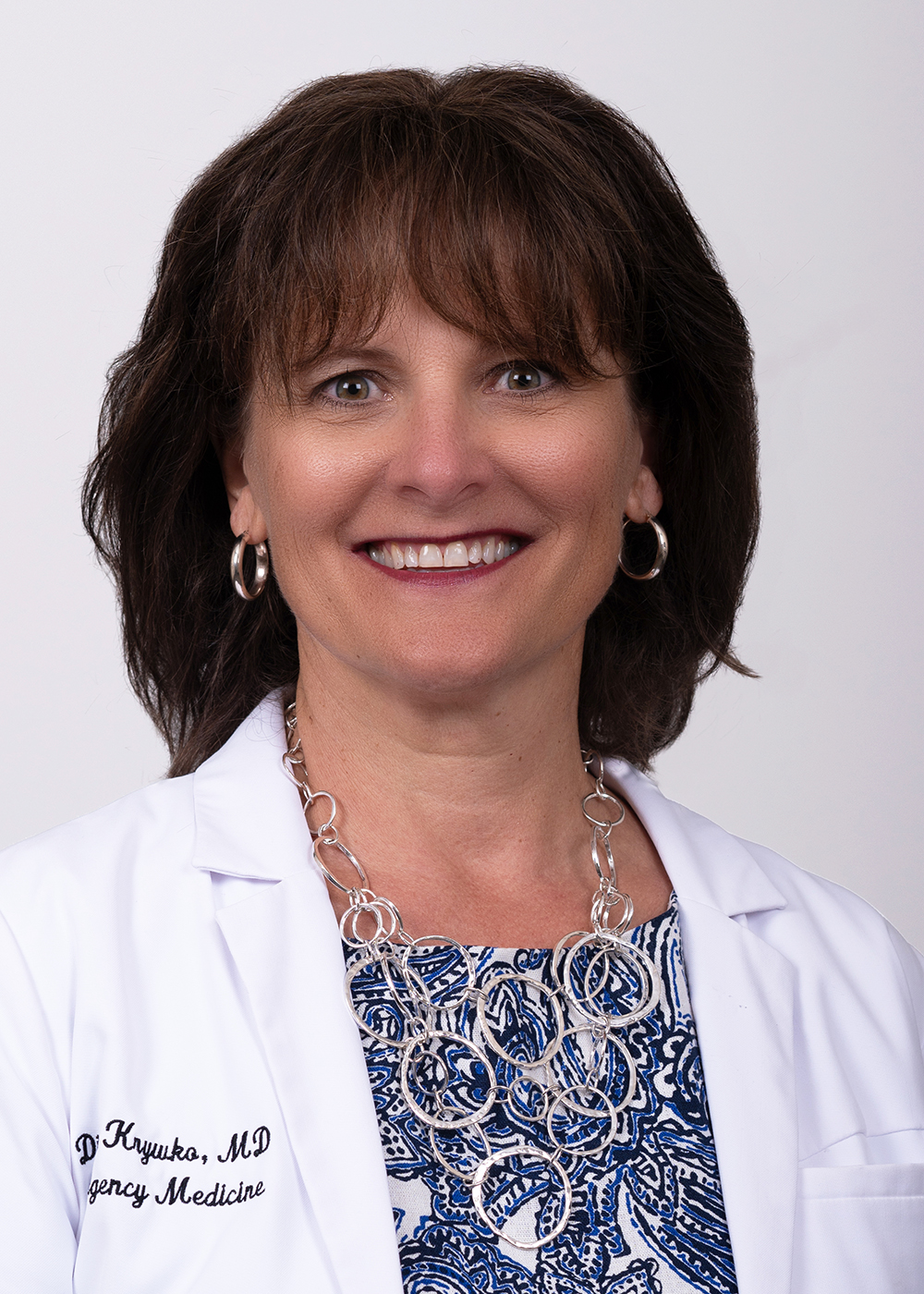 Diann Krykwo, MD, wears a physician's white coat