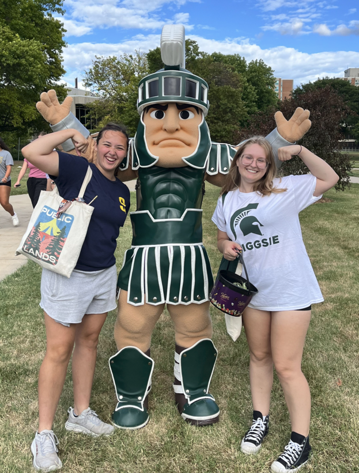 Two students pose with Sparty the mascot