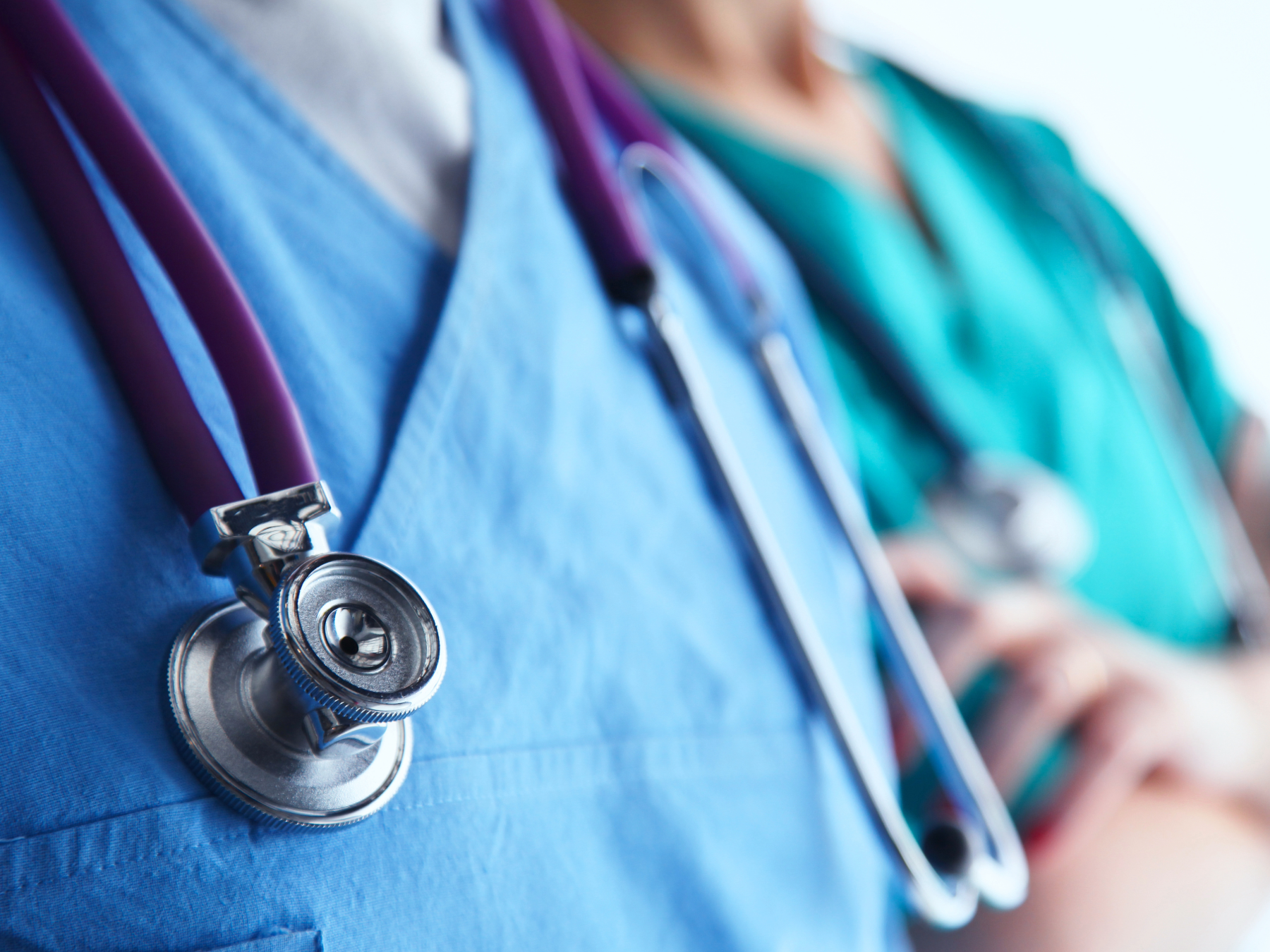 blurred image of medical personnel with a stethoscope in focus