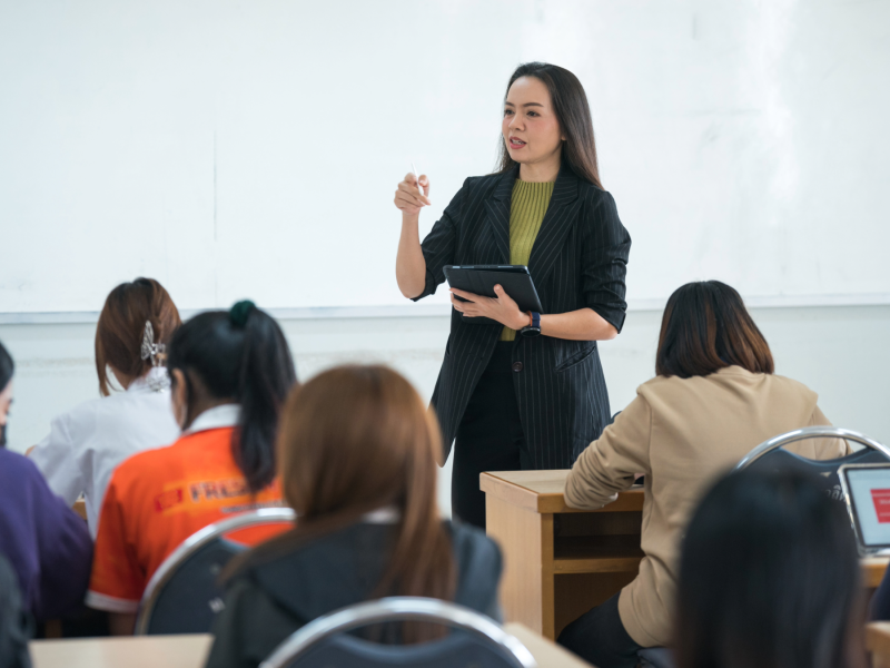 An alumna speaks to a classroom of college students