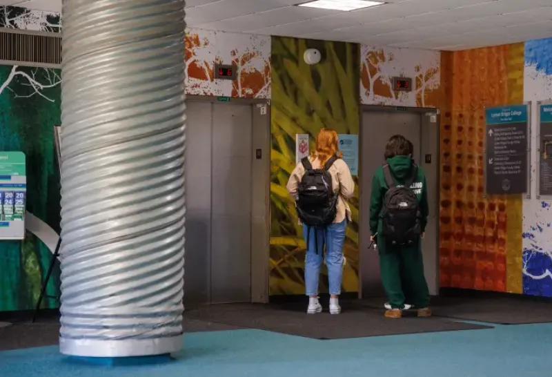 Students walking around the inside of Holmes Hall